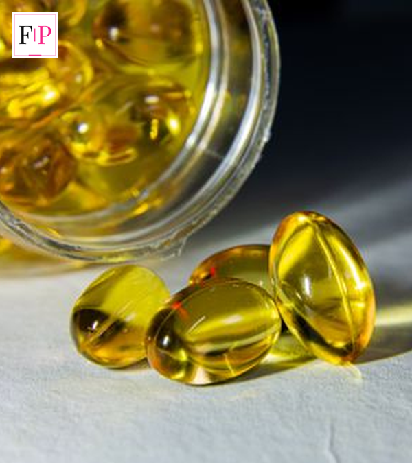 Bottle of vitamin D NHS recommended 10 microgram supplements on a kitchen table