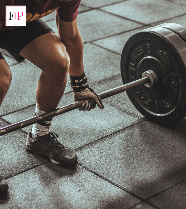 Man training with dumbbells in a gym during his winter arc fitness challenge