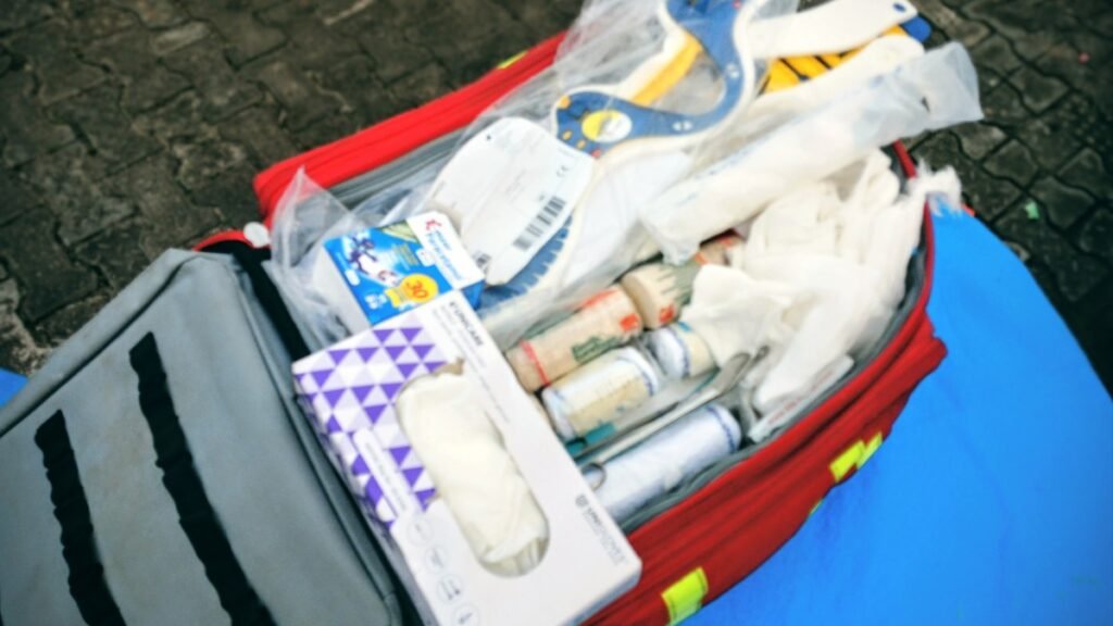 An open emergency first aid kit with medical supplies