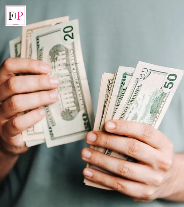 Hands holding and counting banknotes for a best savings accounts uk comparison