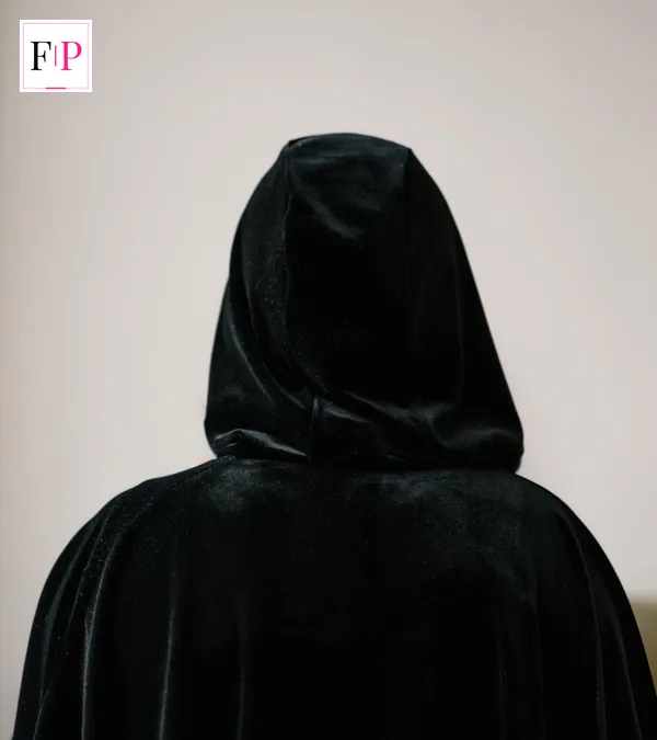 Celebrity Traitors Episode 4: Date, Recap & Shock Exits A figure in a black cloak seen from behind — the hidden Traitor of celebrity traitors episode 4