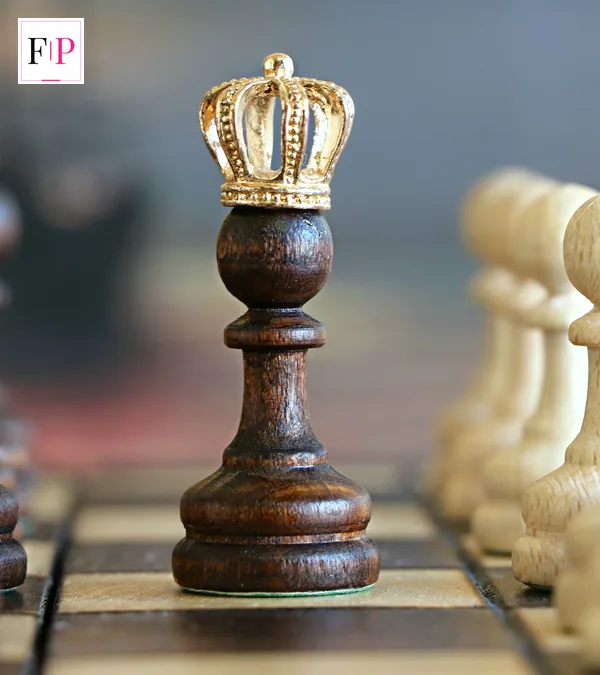 Chess pieces on a board with a crowned pawn in the centre — the strategy behind celebrity traitors episode 5