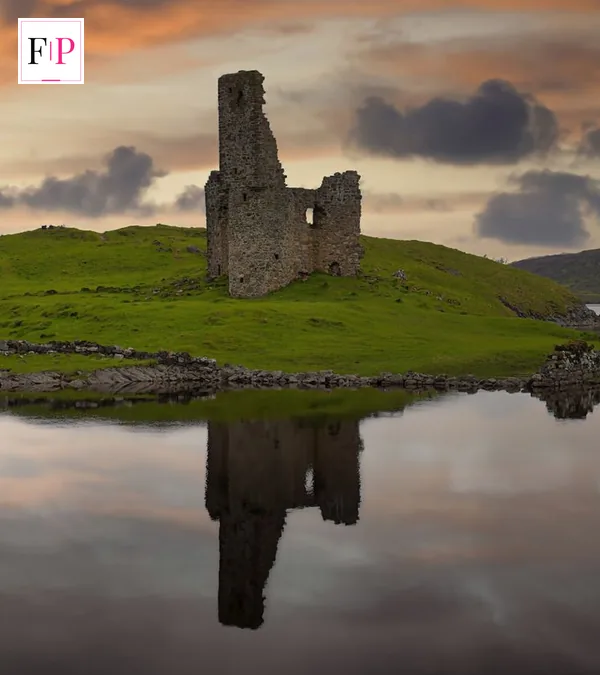 The ruins of Ardvreck Castle reflected in a Highland loch at sunset — the dramatic backdrop to celebrity traitors episode 8