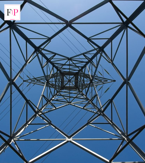 Electricity pylon against a blue sky — energy price cap October 2026