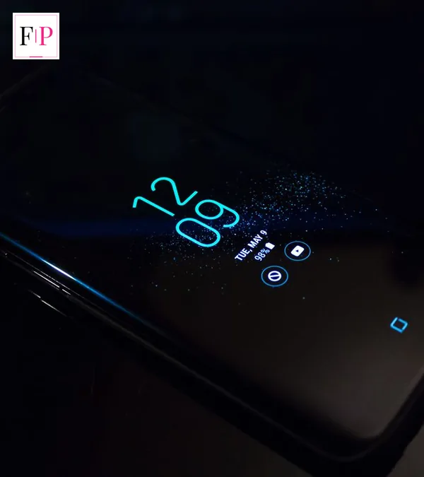 Google Pixel 11: UK Deals Cut Up to £300 Off Pro Fold A smartphone lying on a dark desk showing its clock screen — checking google pixel 11 deals