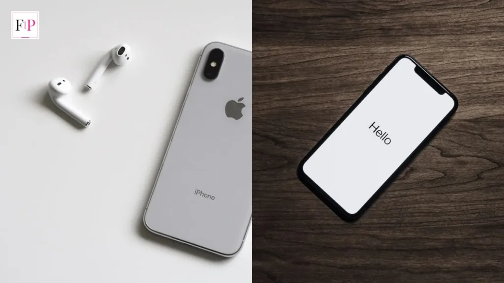 The back of a silver iPhone beside AirPods and an iPhone on a wooden table — iphone 18 pro buying guide