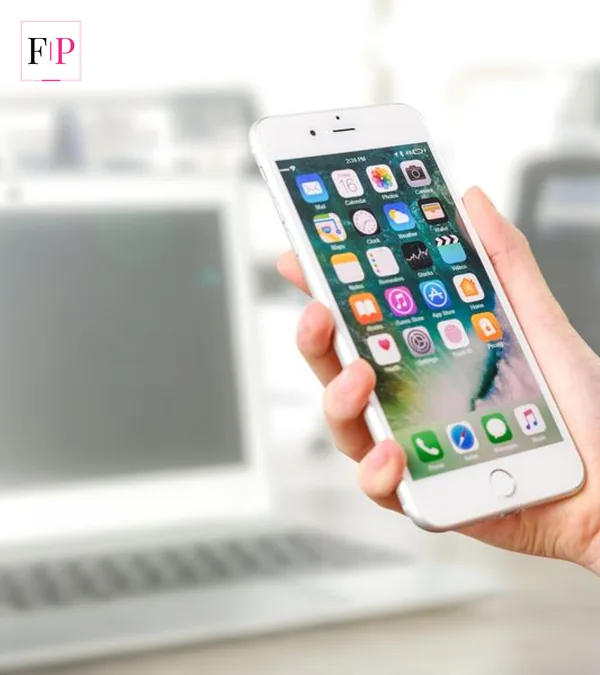 A hand holding an iPhone in an office for this iphone 18 pro guide
