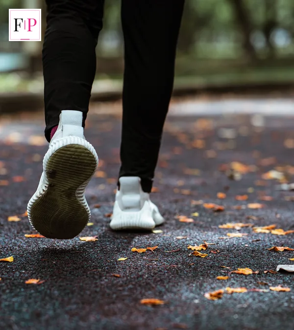 Japanese Walking: The 3-Minute Interval Method Explained White trainers stepping along a leaf-strewn path — comfortable shoes for japanese walking