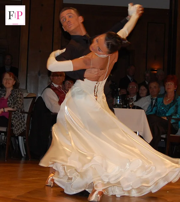 Ballroom couple performing a waltz in front of judges during strictly results show season