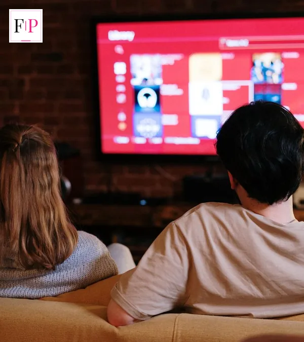 A couple on a sofa at home watching a streaming service on television — ready for the diplomat season 4