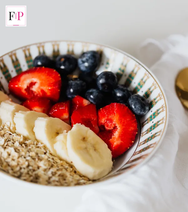 A bowl of oats with banana, strawberries and blueberries — a protein-friendly breakfast for a winter wellness plan